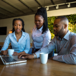 Untitled design (4) 2 black women and black man in an office having a meeting
